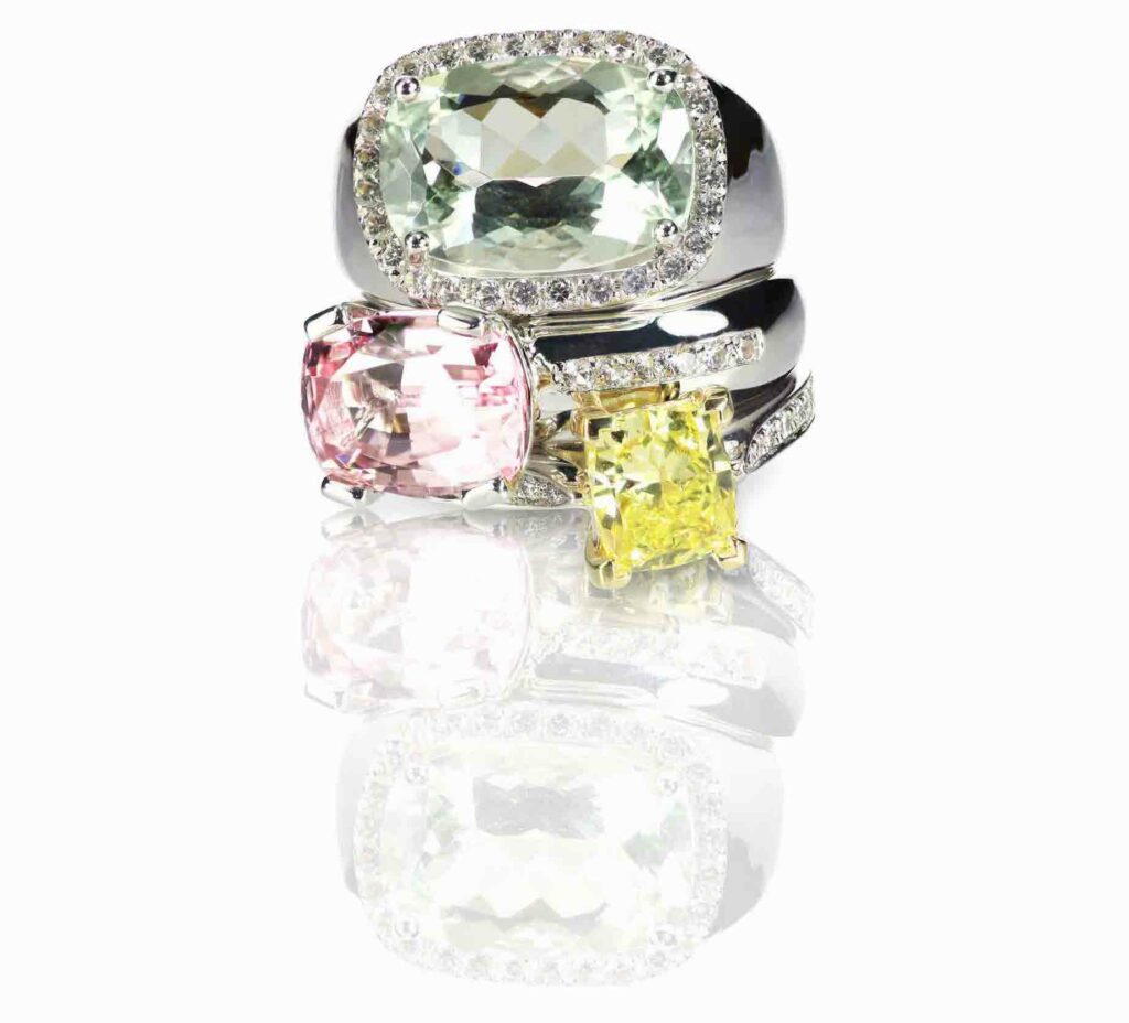 april-birthstone-blog-grouping-of-colored-gemstone-diamond-rings-stacked-OPTIMIZED