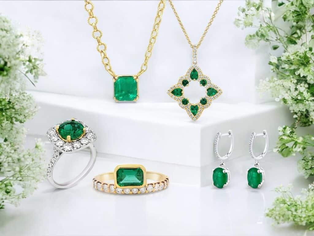 Stunning emerald jewelry display featuring elegant necklaces, rings, and earrings against a soft backdrop.