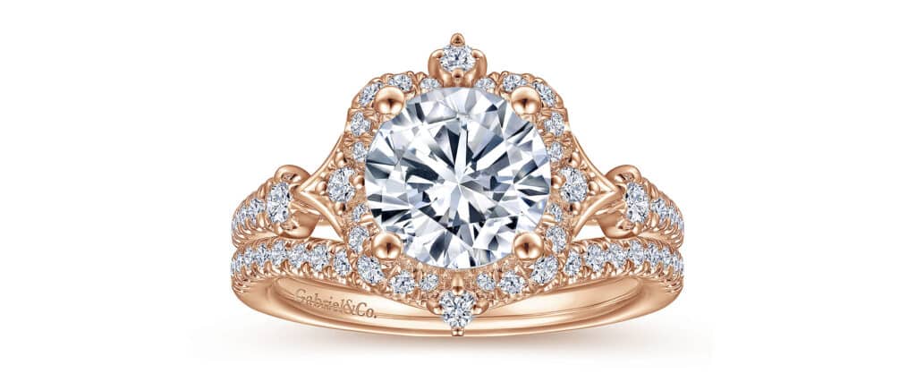 Stunning oval diamond engagement ring in rose gold with halo and intricate detailing.