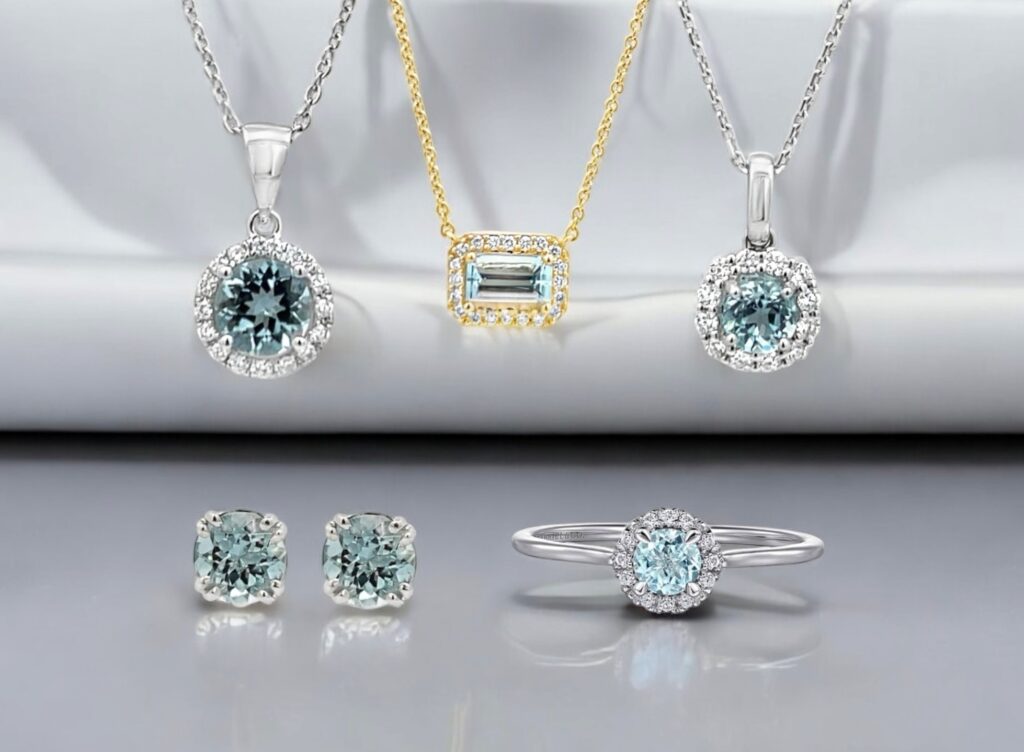 Elegant aquamarine jewelry collection featuring necklaces, earrings, and a stunning ring on gray background.