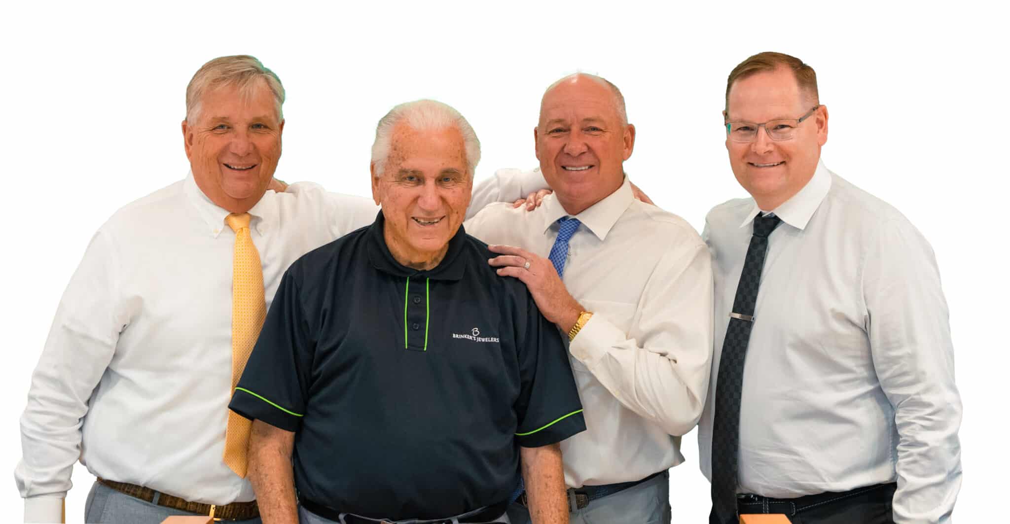 Four men celebrate camaraderie in a friendly pose, showcasing diverse styles and joyful expressions.