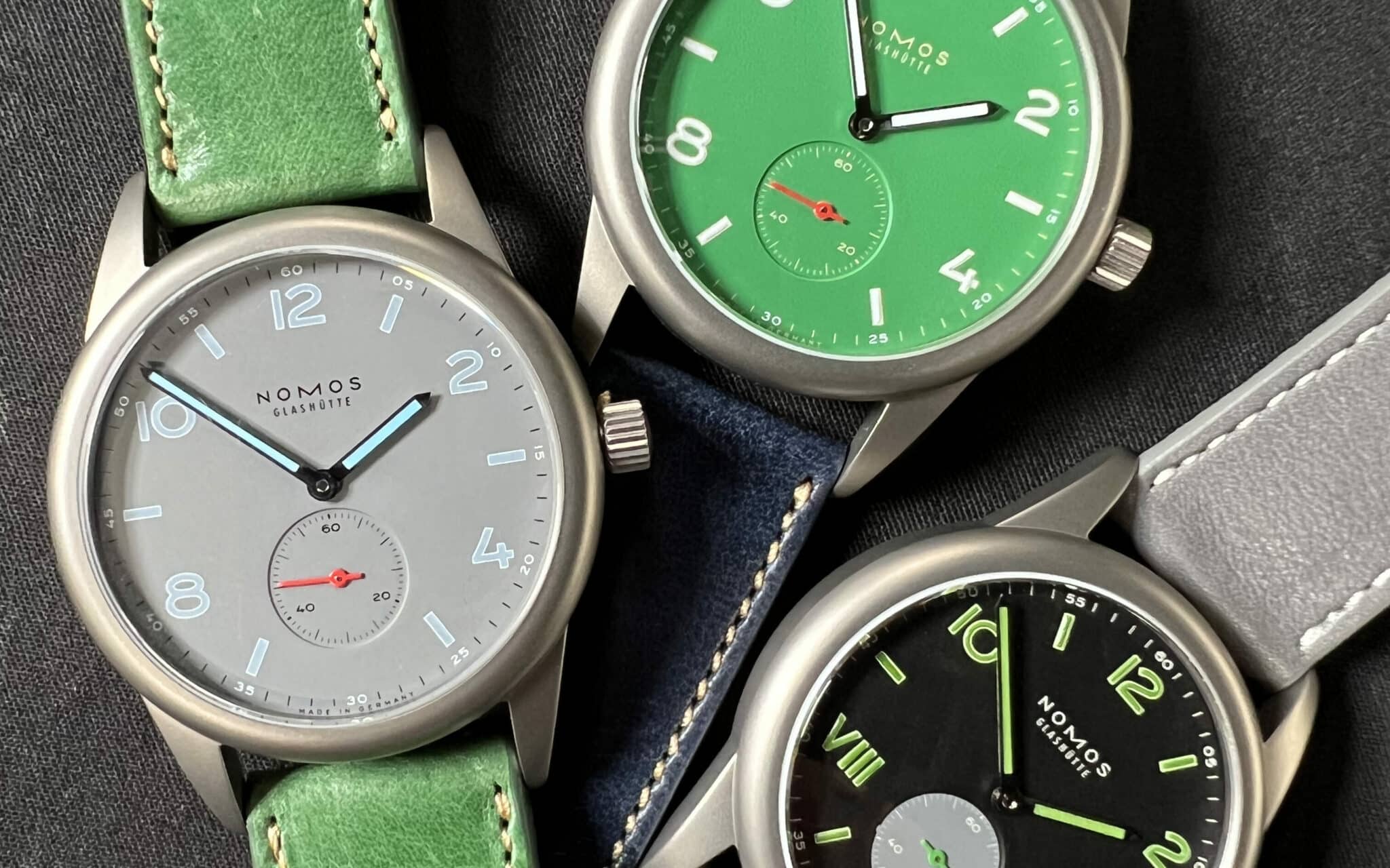 3 Nomos 50 watches placed on a table side by side