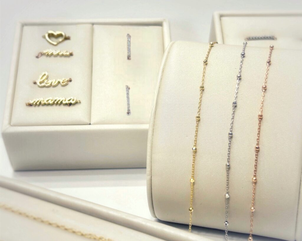 A display of Brinkers jewelers selection of permanent bracelet chains and charms.