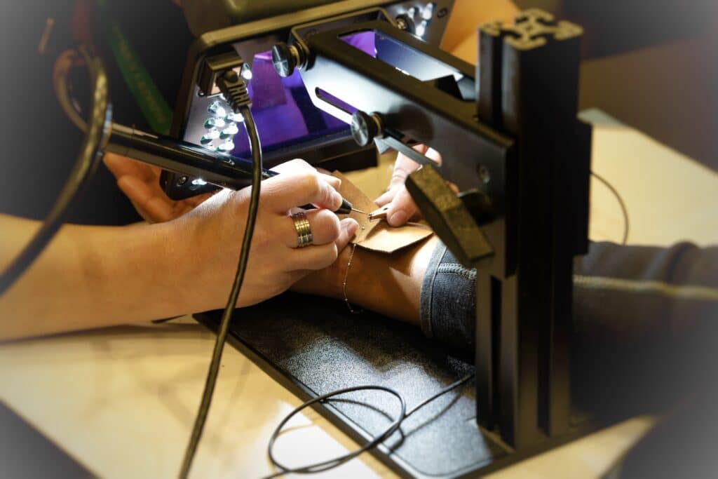 Permanent jewelry bracelet being soldered around a female's writs