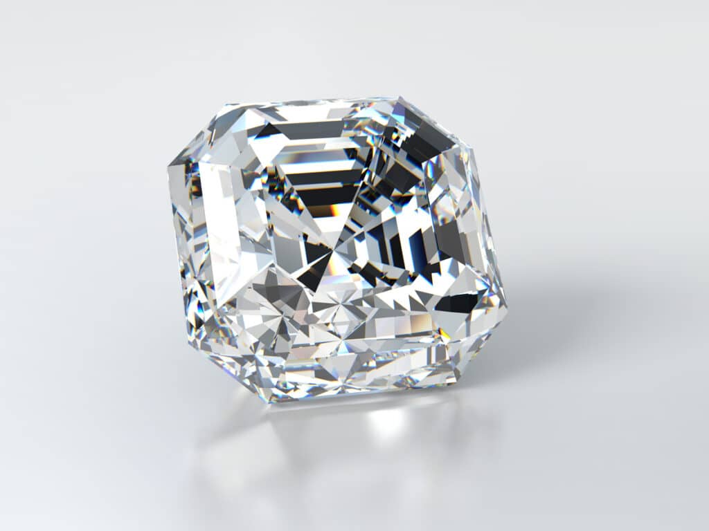 Close-up asscher diamond laying on glossy white background