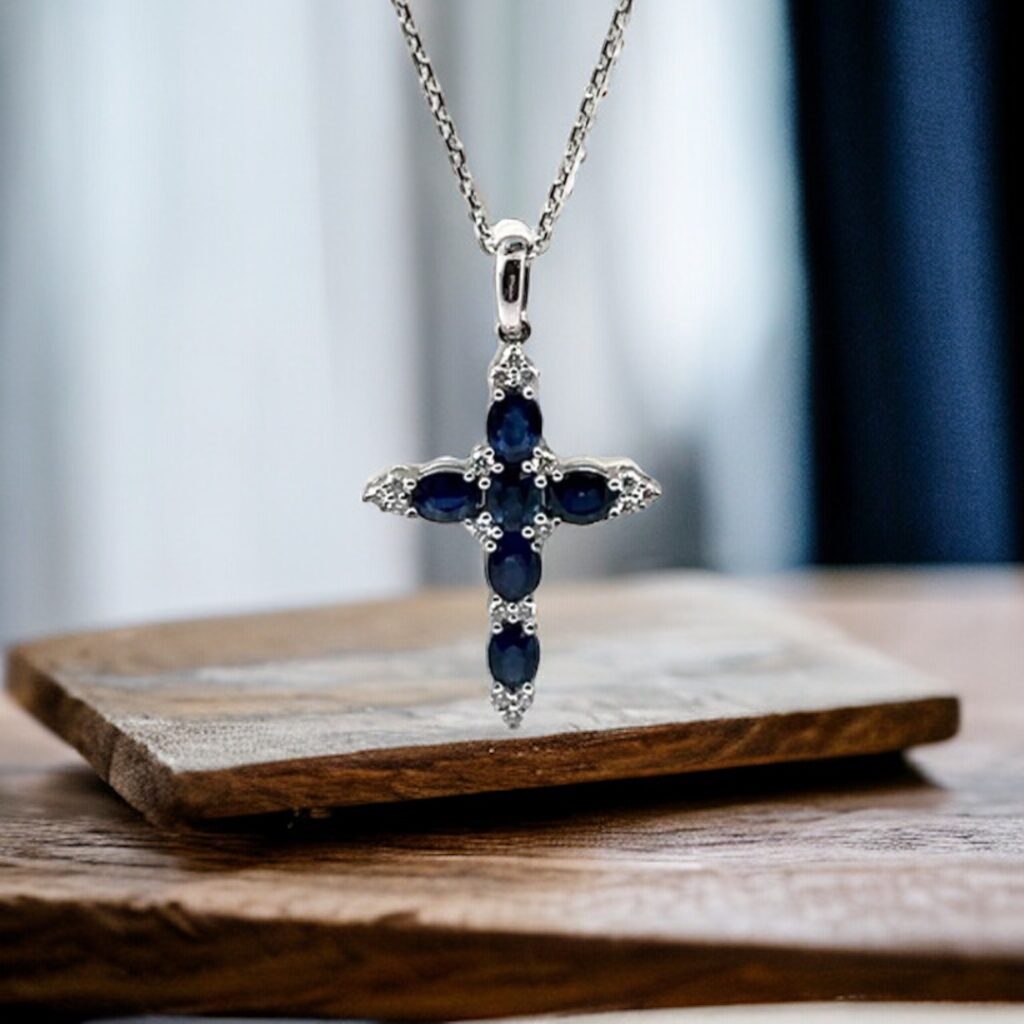 Diamond Cross Necklace dangling against Wood