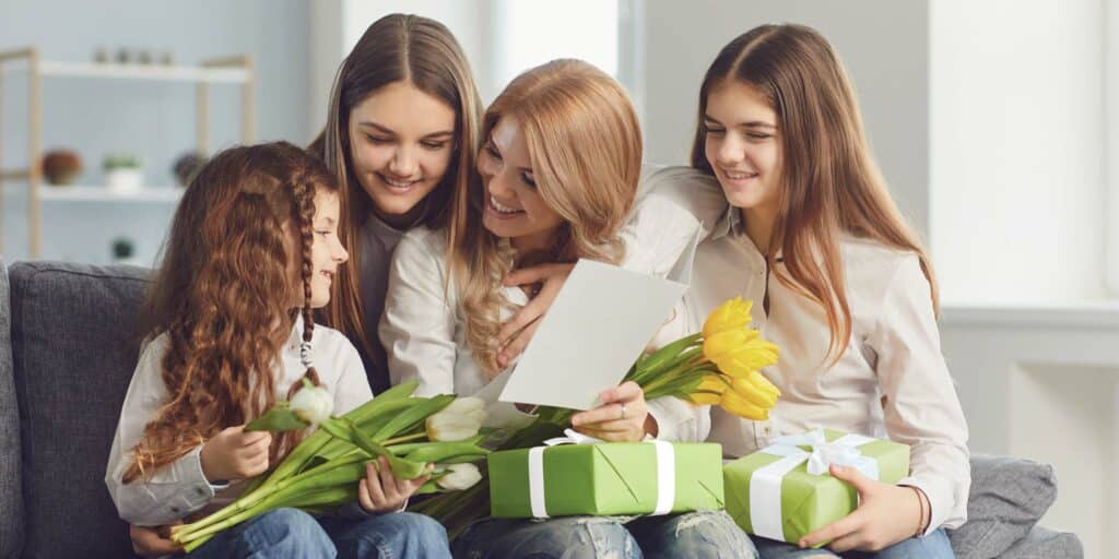 Mother's Day gift being given to mother by her three daughters