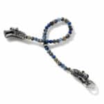 Intricate dragon head beaded accessory with blue and metallic beads, combining artistry and craftsmanship.