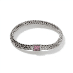 Elegant woven bracelet with pink stone clasp, combining modern design and timeless sophistication.