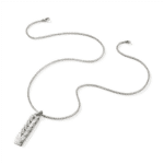Elegant silver necklace with textured pendant, perfect for both casual and formal outfits.