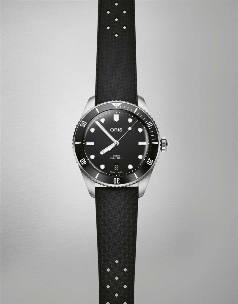 Oris diving watch featuring stainless steel case, black dial, and rubber strap for underwater adventures.