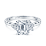 Elegant engagement ring featuring an emerald-cut diamond and baguette side stones for timeless beauty.