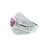 Stunning pink pear-shaped gemstone ring with diamond accents in a sleek silver setting.