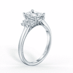 Elegant emerald cut diamond engagement ring featuring tapered baguette sides in a sleek band.