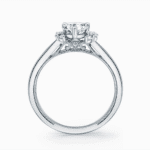 Elegant engagement ring with a central diamond and intricate vintage design details.
