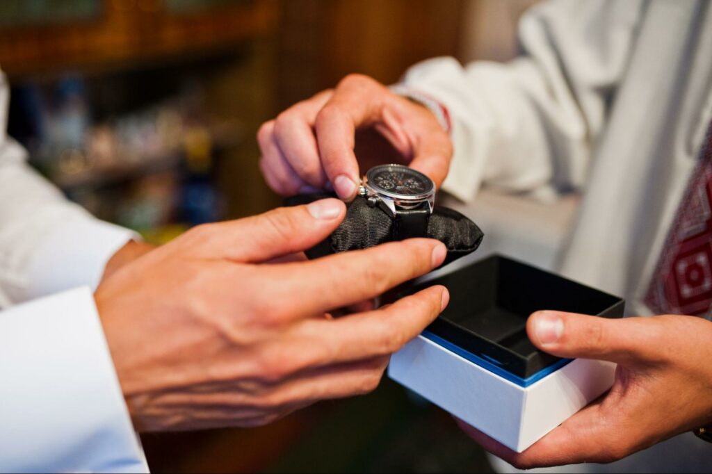 Elegant watch exchange captures intimate connection and appreciation in a warm, cozy setting.