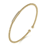 Elegant gold bracelet with beaded design and sparkling gemstones, perfect for any occasion.