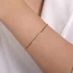 Elegant gold bracelet with sparkling gems on a smooth wrist, perfect for any occasion.