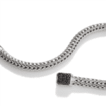 Elegant silver braided bracelet with black stone clasp, perfect for any occasion.