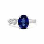Elegant ring featuring a deep blue sapphire and sparkling diamonds in a polished band.