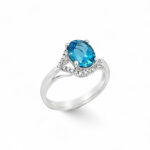 Elegant blue gemstone ring with diamonds, perfect for engagements and special occasions.