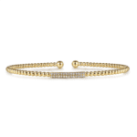 Elegant gold bracelet with spherical beads and a sparkling stone bar for versatile style.
