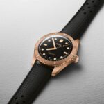 Luxurious Oris dive watch with a bronze case, black dial, and rubber strap.