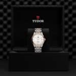 Luxurious Tudor watch in elegant presentation box, showcasing craftsmanship and sophisticated design.