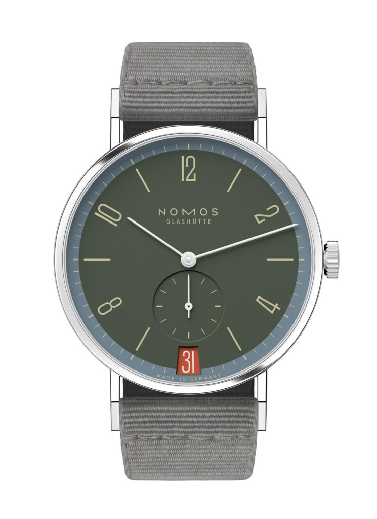 NOMOS Glashütte watch, minimalist design, deep green dial, stainless steel, elegant fabric strap.