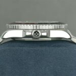 Luxury stainless steel watch profile with polished finish, textured bezel, and signed crown.