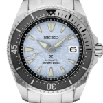 Seiko automatic dive watch with blue dial, stainless steel case, and luminescent markers.