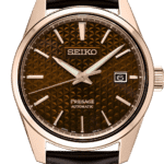 Elegant Seiko Presage watch with rose gold case, leather strap, and unique brown dial.