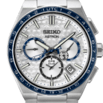 Seiko Astron watch features a silver dial, blue bezel, and solar technology for modern elegance.