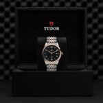 Luxury Tudor watch with rose gold accents, displayed in an elegant black box.