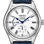 Elegant Seiko Presage watch with blue accents, Roman numerals, and luxurious leather strap.