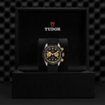 Elegant Tudor chronograph watch in a luxurious presentation box with striking gold accents.