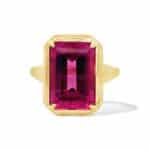 Elegant pink emerald-cut gemstone ring set in polished gold, perfect for any occasion.