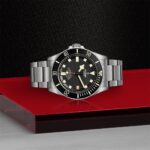 Luxurious Tudor watch with black dial, stainless steel case, and unidirectional rotating bezel.