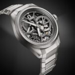 Elegant Oris mechanical watch with skeleton dial, brushed titanium finish, and robust metal bracelet.