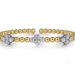 Elegant gold and silver bracelet with floral motifs and sparkling accents for stylish accessories.