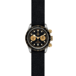 Elegant Tudor watch with black dial, gold accents, and sporty chronograph functionality.