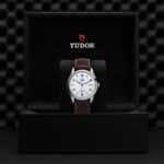 TUDOR elegant watch in luxurious box with brown leather strap and classic design displayed.