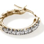 Elegant dual-tone hoop earrings with diamonds and gold chain detailing for a luxurious statement.