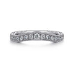 Elegant white metal ring with sparkling diamonds and intricate milgrain design, perfect for engagements.