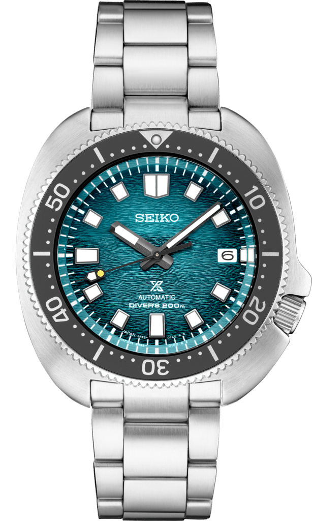 Vibrant Seiko dive watch with teal dial, luminous hands, and stainless steel bracelet.