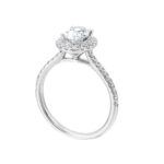 Elegant oval-cut diamond engagement ring with halo and white gold band.