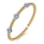 Elegant gold and silver gemstone bracelet with unique design and modern sophistication.