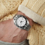Stylish Seiko dive watch on wrist against cozy knitted sweater for ultimate comfort and elegance.