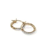 Elegant gold hoop earrings with interlocking links and sparkling gemstones for a luxurious look.