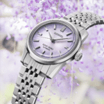 Elegant King Seiko automatic watch surrounded by soft purple blossoms, showcasing luxury and craftsmanship.